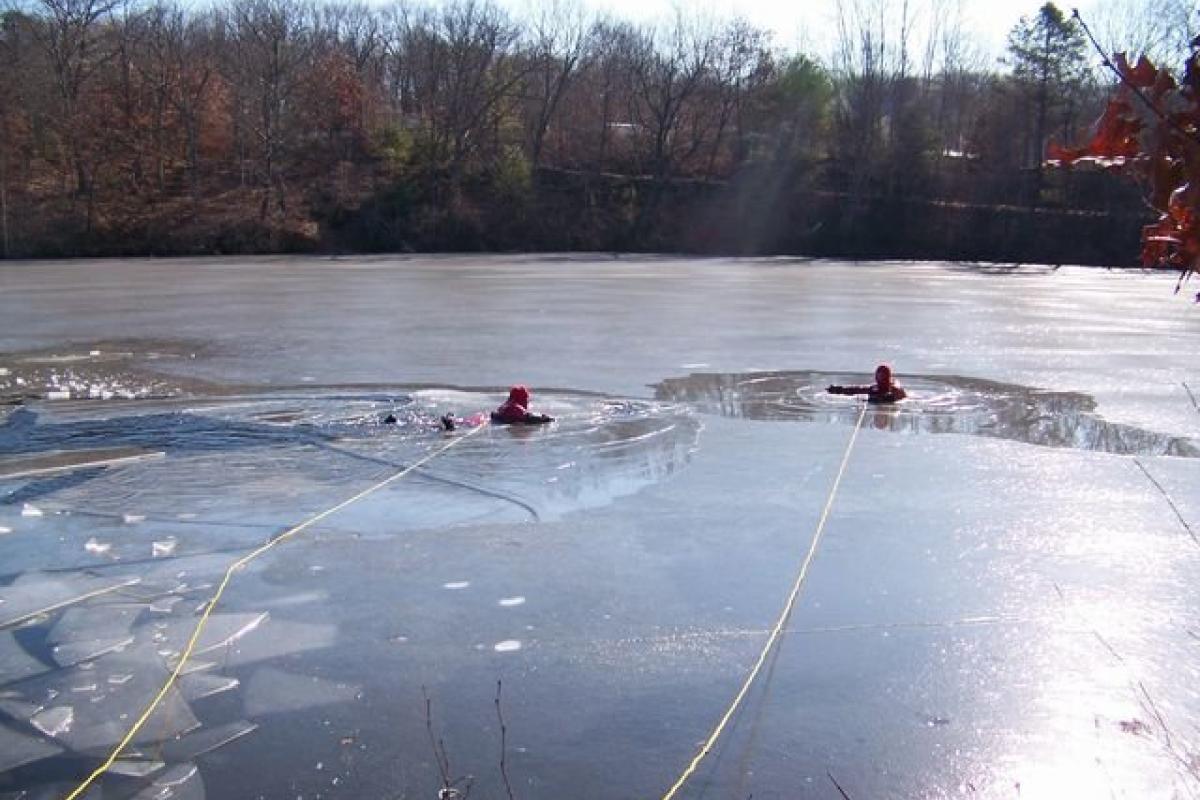 two_men_floating_separately_in_icy_lake